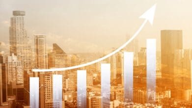 A rising bar chart superimposed over a city skyline, symbolizing financial growth and economic progress. This represents how Business Loans in the Philippines empower entrepreneurs and SMEs to expand and succeed.