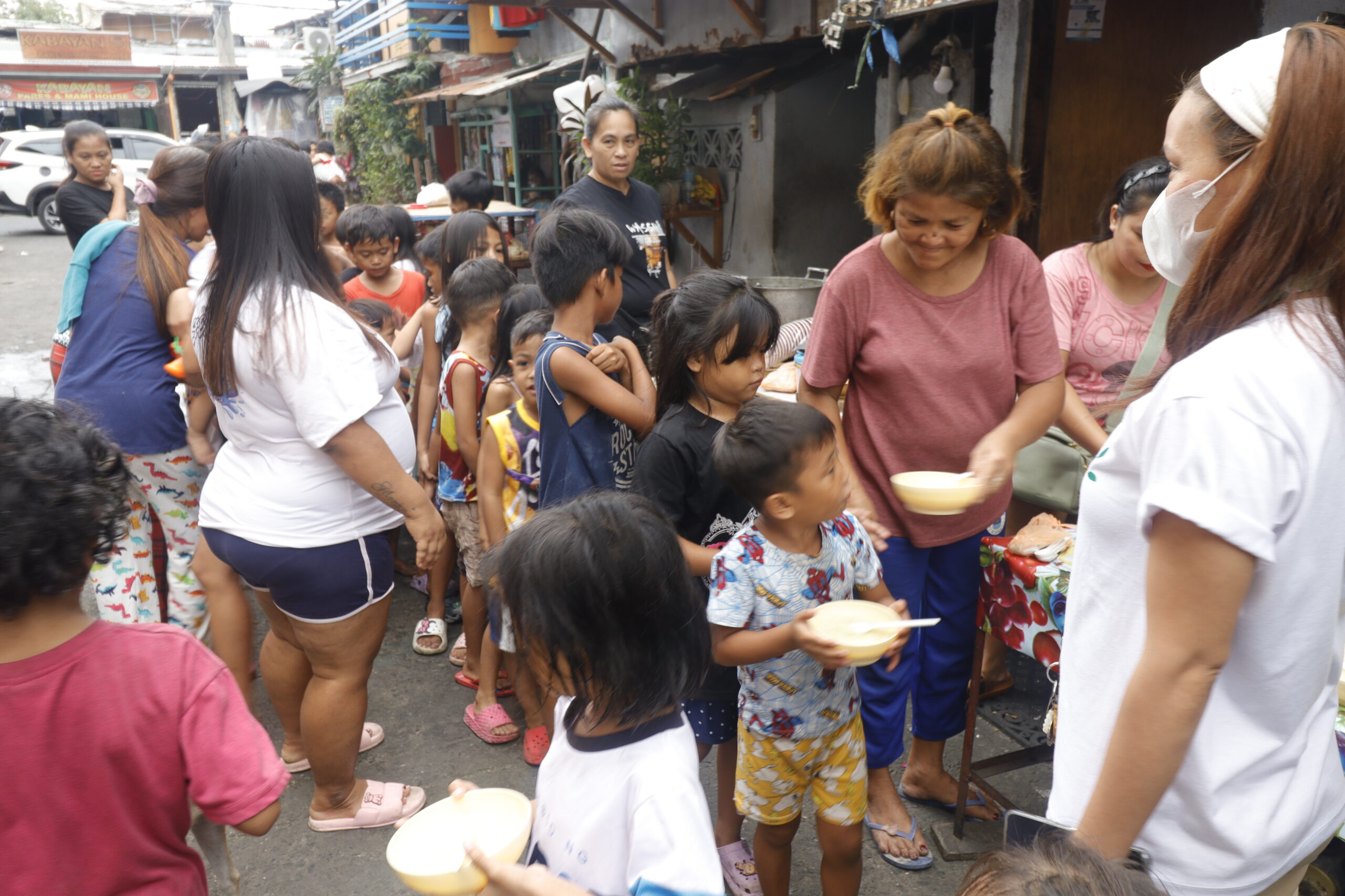 Children line up for feeding program initiated by Sagip Batampalengke volunteers.